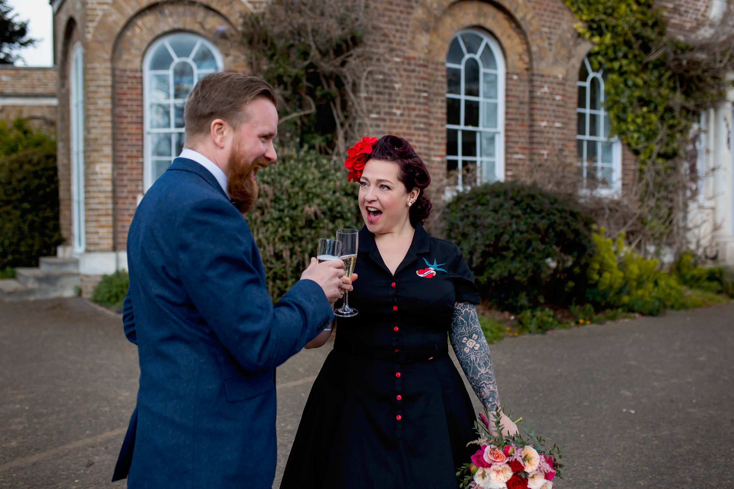 couple celebrating with champagne covid19 micro wedding at morden hall registry office